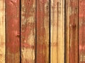 Red yellow orange painted fading weathered backyard garden fence wood boards architectural background