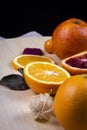 Red and yellow oranges next to its slices Royalty Free Stock Photo