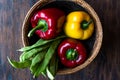 Red and Yellow Pepper with Green Runner Beans in Wooden Basket. Royalty Free Stock Photo