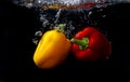red and yellow peppers splash come into water Royalty Free Stock Photo