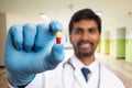 Red and yellow pill presented by medic Royalty Free Stock Photo