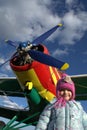 Red and yellow plane with little girl Royalty Free Stock Photo