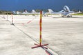 Red and yellow pole sign with a chain prohibits people of passing on an airport Royalty Free Stock Photo