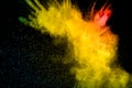 Red yellow  powder explosion on black background.Red yellow color dust splash clouds Royalty Free Stock Photo