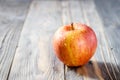 Red yellow ripe apple Royal Gala with water drops closeup on blurred background on wooden table Royalty Free Stock Photo