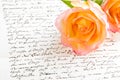 Red yellow rose over a hand written letter Royalty Free Stock Photo