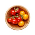 Red and yellow small cherry tomatoes in wooden bowl isolated on white background Royalty Free Stock Photo