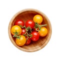 Red and yellow small cherry tomatoes in wooden bowl isolated on white background Royalty Free Stock Photo