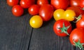 Red and yellow tomatoes on a dark background, fresh tomatoes on an old wooden table,growing vegetables,healthy food, vegetarian Royalty Free Stock Photo