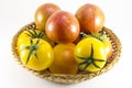 Red and yellow tomatoes in wicker oval shape