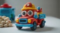 A red and yellow toy fire truck with a yellow fireman hat Royalty Free Stock Photo