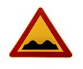 Red and yellow triangular warning road sign with a warning of a bumpy road ahead