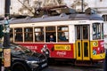 Red and Yellow Trolley Car Traveling Down Street. Lisbon, Portugal