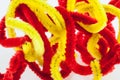 Red and yellow twisted pipe cleaners Royalty Free Stock Photo