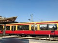 Red and yellowish traditional S Bahn train in a platform in Berlin city