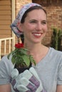 Red Zinnia being held by smiling woman. Royalty Free Stock Photo