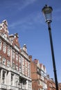 Redbricked houses, blue skies and a lamp post. Royalty Free Stock Photo