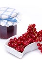 Redcurrants in a small dish and a jar of redcurrant jam Royalty Free Stock Photo