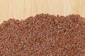 Reddish Brown seeds of Linseed, also called flaxseed on wooden b