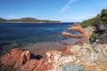 Reddish rocks of Rondinara Bay coastline Royalty Free Stock Photo