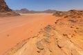 Reddish sand and rock landscapes in the desert of Wadi Rum, southern Jordan