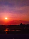 Reddish sunrise in farmland