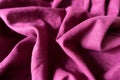 Reddish violet linen fabric with folds and shadows