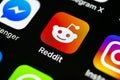 Reddit application icon on Apple iPhone X smartphone screen close-up. Reddit app icon. Reddit is an online social media network.