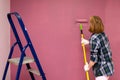 Redecorating. Painting walls with paint-roller Royalty Free Stock Photo