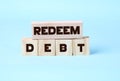 REDEEM debt words written on wooden cubes Business concept