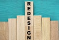 REDESIGN - word on wooden bars on a green background