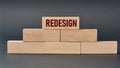 REDESIGN - word on wooden blocks on dark background