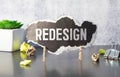 REDESIGN word written on wood block. REDESIGN text on wooden table for your desing, concept