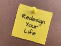 Redesign your life text on yellow notepad.