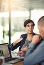 Redesigning their strategy. colleagues having a discussion in a boardroom.