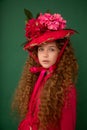 Redhair beautiful girl with curly afro curls in bright pink dress on green background. Curly hair care, freckle cream, teen book