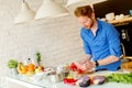 Redhair young man cooking food Royalty Free Stock Photo