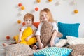 Redhaired children among pillows