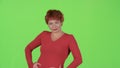Redhaired flirts and winks with the men. Green screen