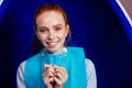 Redhaired ginger young cheerful female client sitting in dental office and getting smile whitening in egg chair Royalty Free Stock Photo