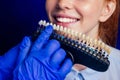 Redhaired ginger young cheerful female client sitting in dental office and getting smile whitening in egg chair Royalty Free Stock Photo