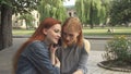 Two girls talking on the same phone Royalty Free Stock Photo