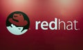 Redhat logo and letters on a red wall Royalty Free Stock Photo