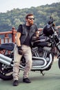 Redhead biker with beard in leather jacket and his bike.