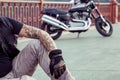 Redhead biker with beard in leather jacket and his bike.