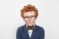 Redhead boy in blue suit with bow tie on white Royalty Free Stock Photo