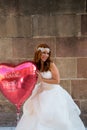 Redhead bride with a big balloon heart shaped Royalty Free Stock Photo