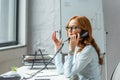 Businesswoman gesturing and talking on landline Royalty Free Stock Photo