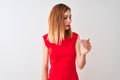 Redhead businesswoman wearing elegant red dress standing over isolated white background Beckoning come here gesture with hand