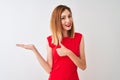 Redhead businesswoman wearing elegant red dress standing over isolated white background Showing palm hand and doing ok gesture Royalty Free Stock Photo